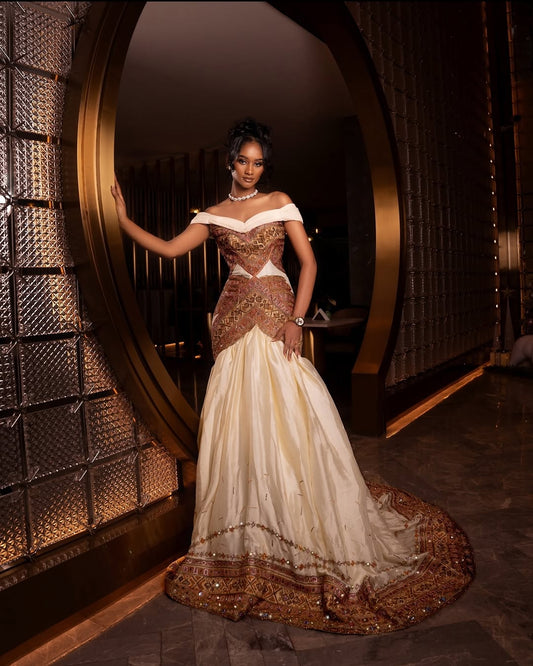 Woman in a traditional habesha dress standing in a decorative interior setting