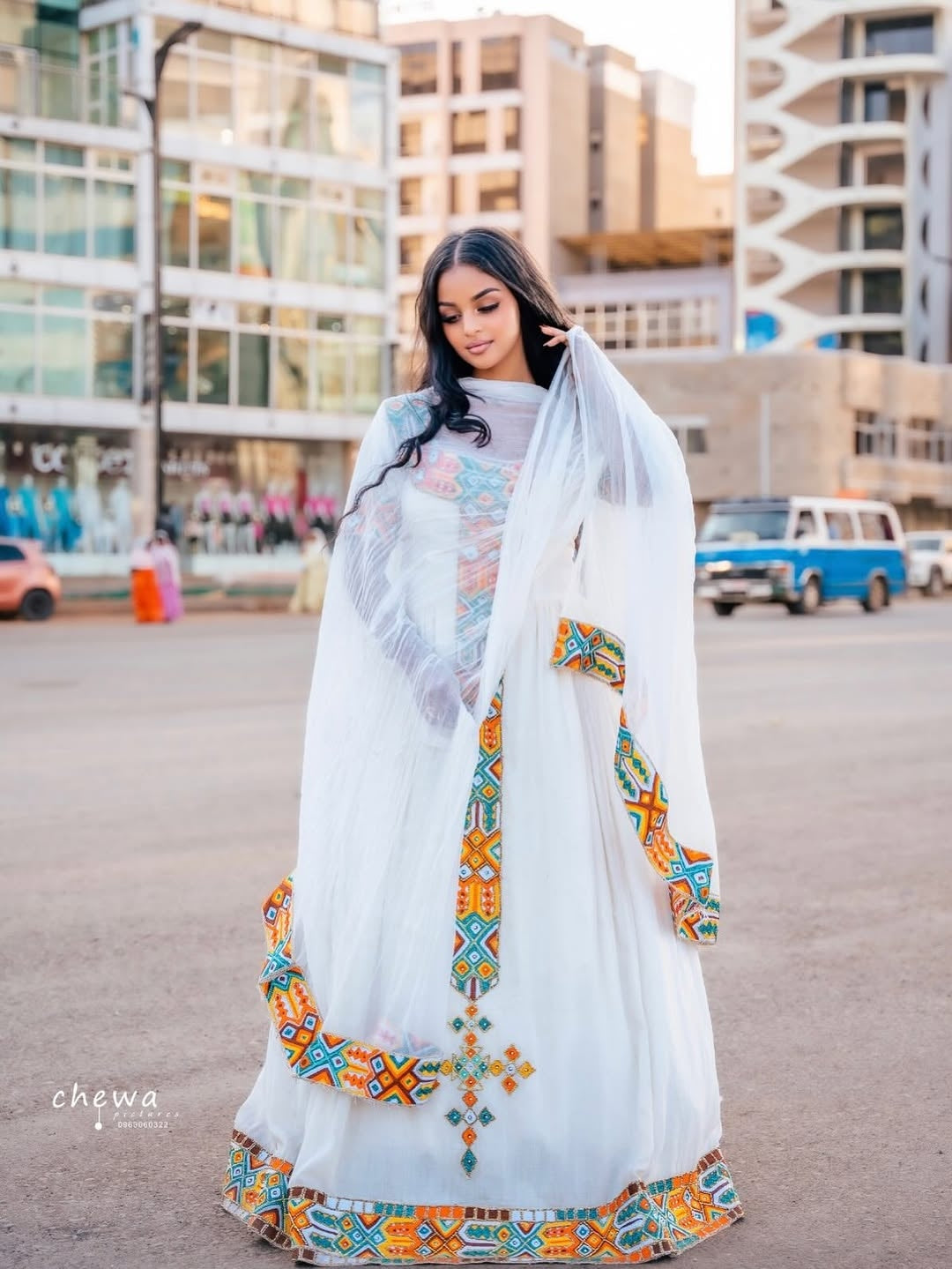 Woman wearing a Ethiopian Traditional Dresswith colorful embroidery in an urban setting
