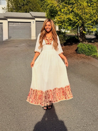 Red Habesha dress in handwoven cotton featuring gold tilf embroidery for weddings
