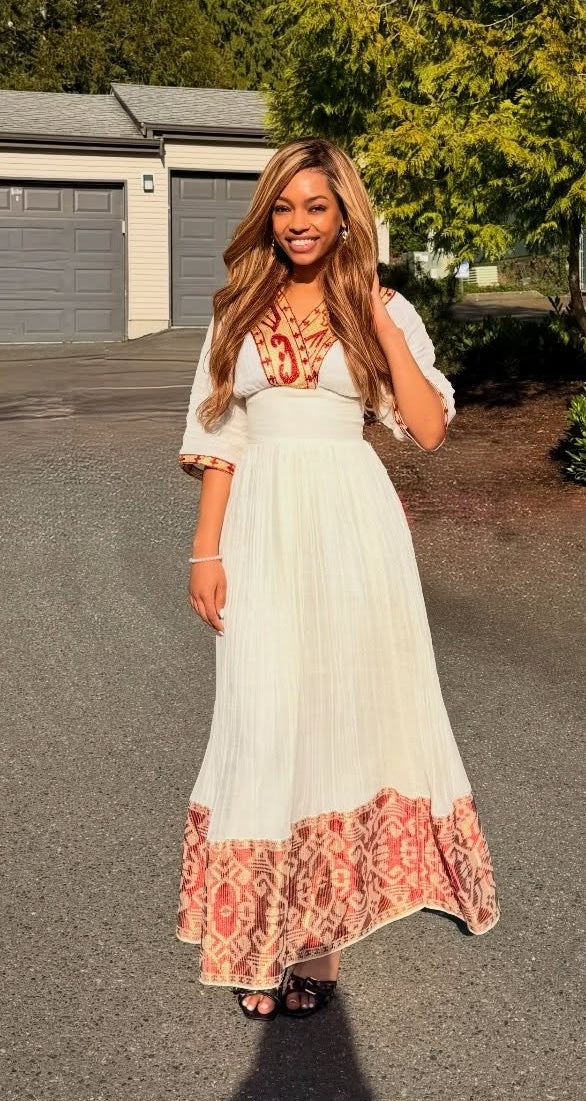 Red Habesha dress in handwoven cotton featuring gold tilf embroidery for weddings