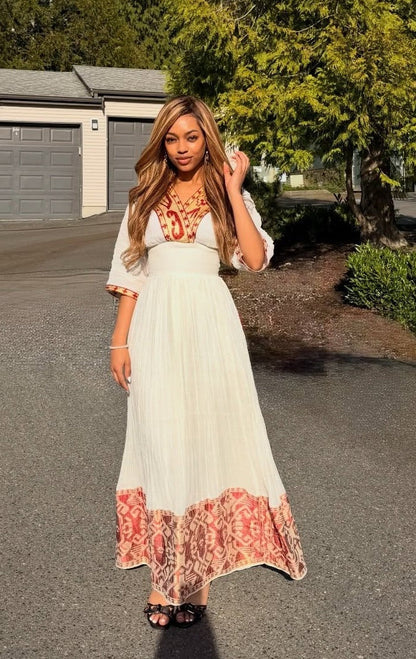 Red Habesha dress in handwoven cotton featuring gold tilf embroidery for weddings