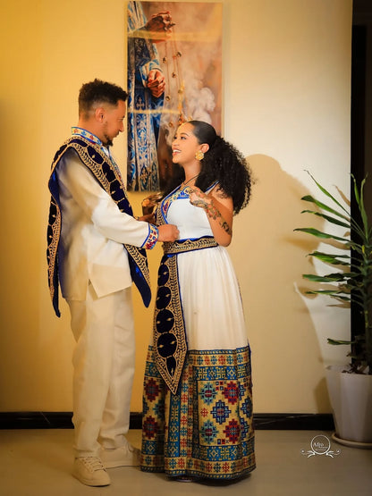 Couple in traditional Ethiopian Matching Couple Set standing close together indoors.