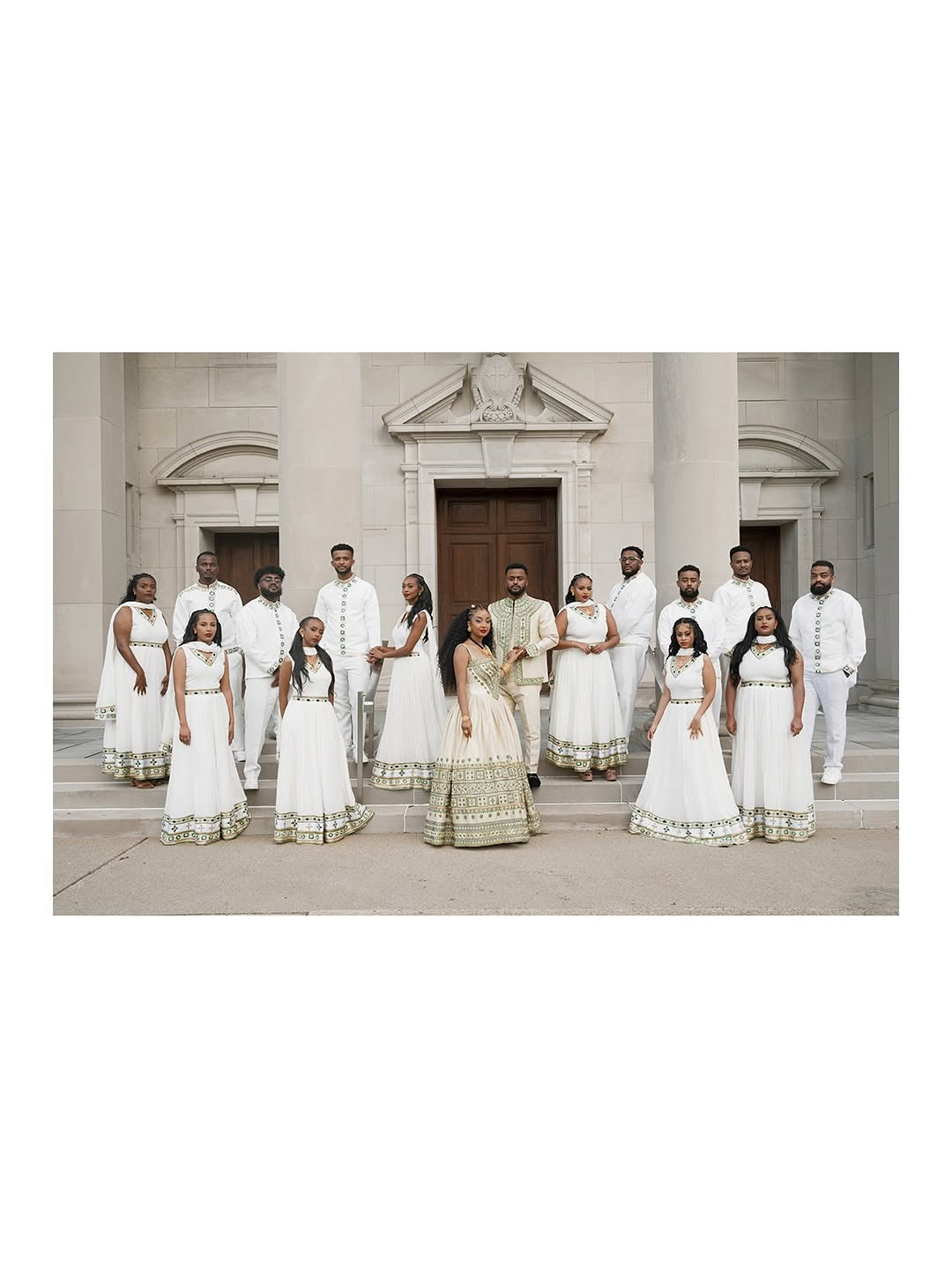 Group of people in formal Couple Set standing in front of a classical building.