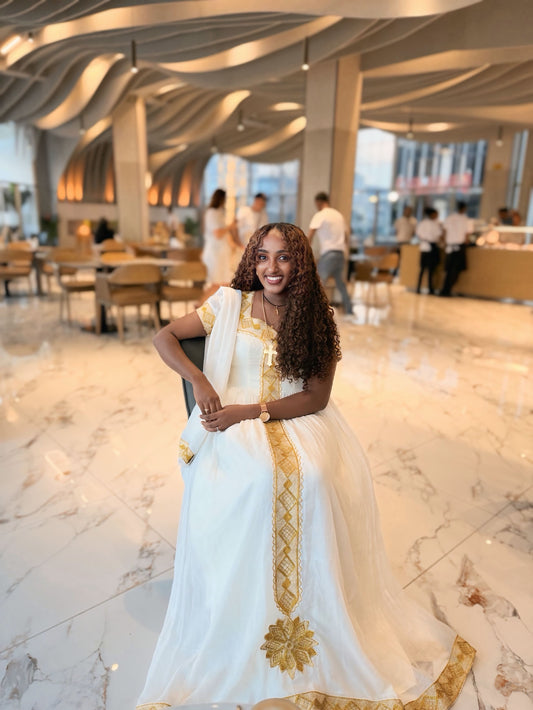 Gold Embroidered Habesha Dress from the Ethiopia Store Online – Flowing Traditional Style for New Year's Eve Parties