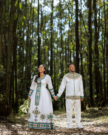 Couple in traditional Green Habesha Wedding Couple Outfit standing in a forest