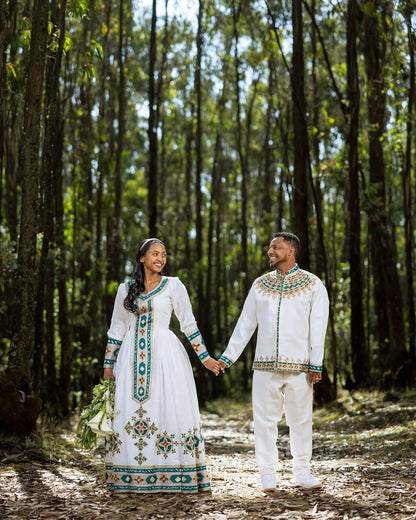 Couple in traditional Green Habesha Wedding Couple Outfit standing in a forest
