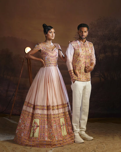 Man and woman in traditional Habesha Outfit couple Set  standing against a textured brown background