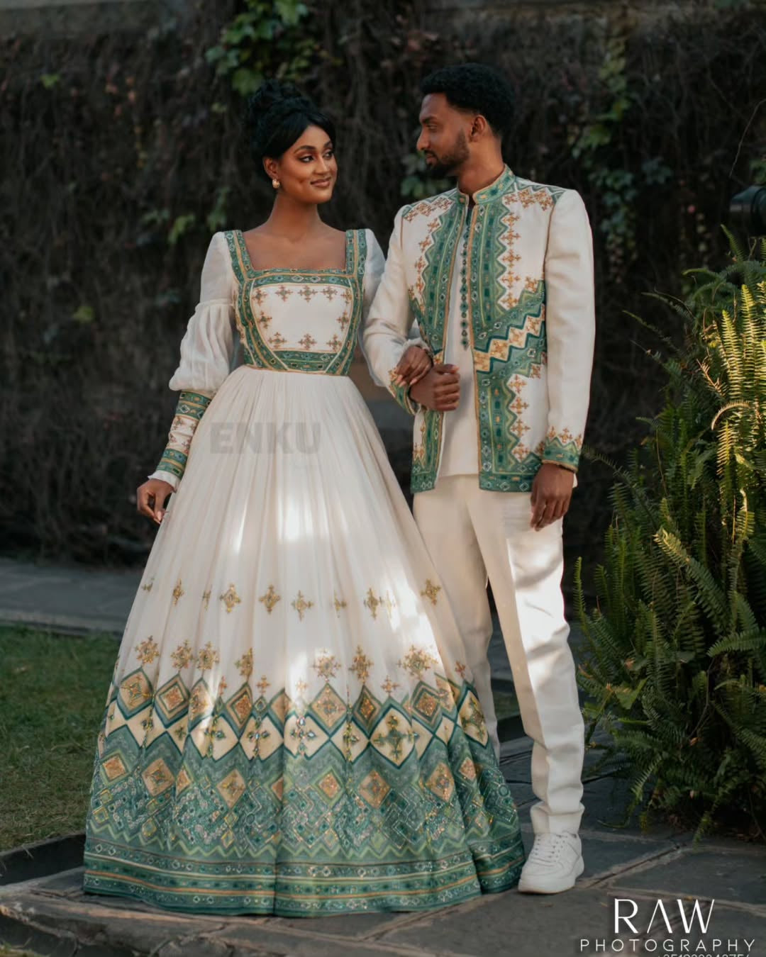 Man and woman in traditional embroidered Habesha Outfit couple Set  standing outdoors.