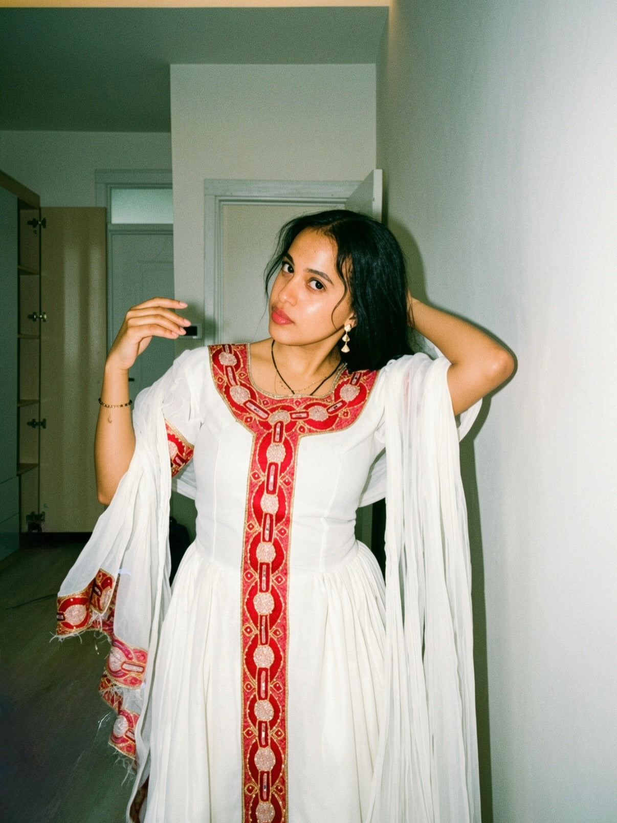 Red cotton Habesha kemis with gold tibeb embroidery for New Year gatherings