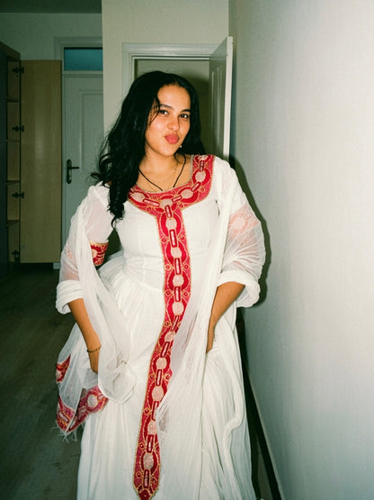 Red cotton Habesha kemis with gold tibeb embroidery for New Year gatherings