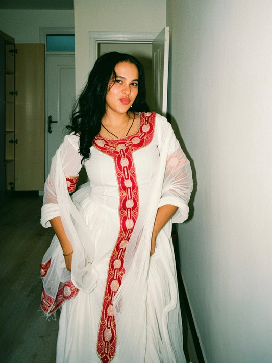 Red cotton Habesha kemis with gold tibeb embroidery for New Year gatherings