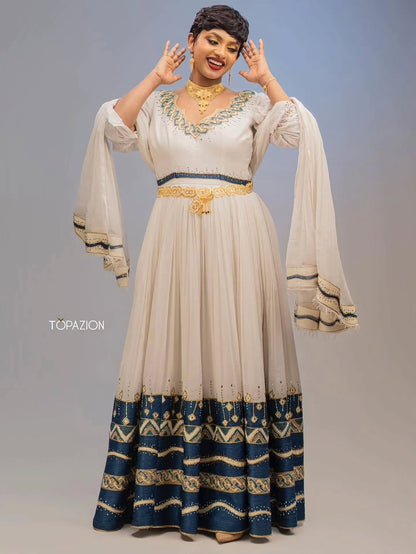 Woman wearing a Habesha Couple Matching Set with a blue and white pattern, posing against a gray background.