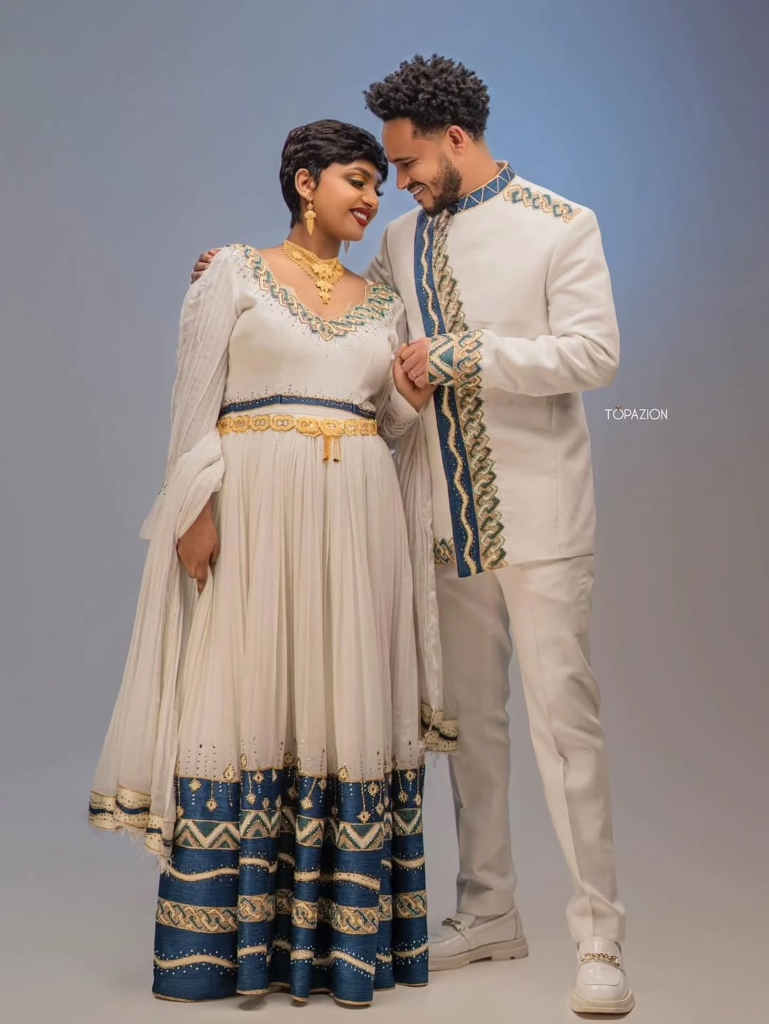 Man and woman in Habesha Couple Matching Set attire standing close together against a plain background