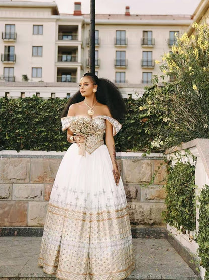 Gold Modern Habesha Wedding Dress – Contemporary Off-Shoulder Bridal dress with Geometric Tilet