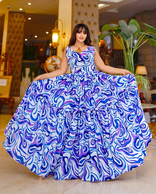 Woman in a blue and purple patterned Chiffon Zuria standing in an indoor setting with plants and decor.