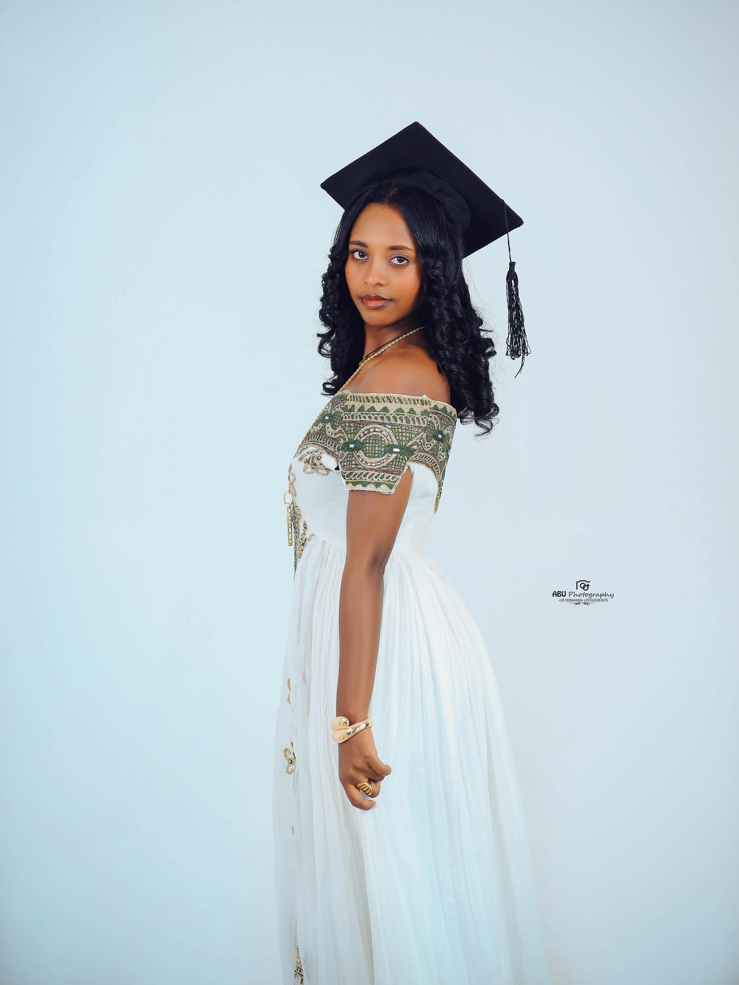 Green Habesha zuria in soft chiffon featuring gold embroidery for graduation celebrations