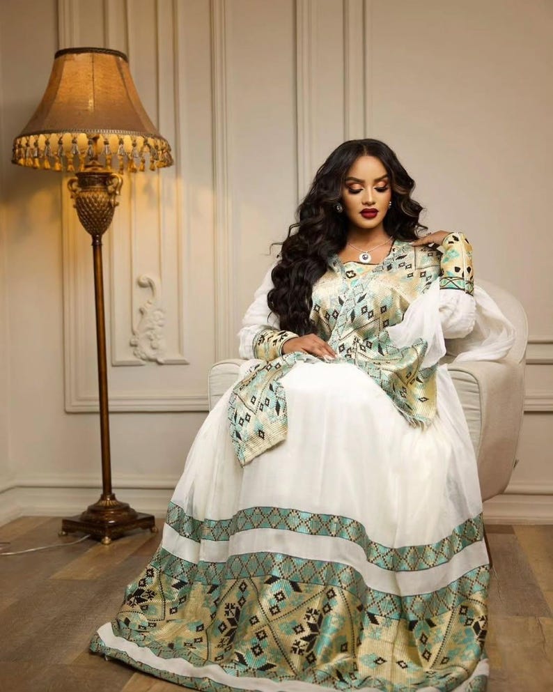 Green Habesha kemis in soft dress featuring gold tibeb embroidery for holiday ceremony