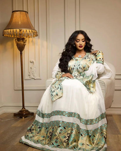 Green Habesha kemis in soft dress featuring gold tibeb embroidery for holiday ceremony