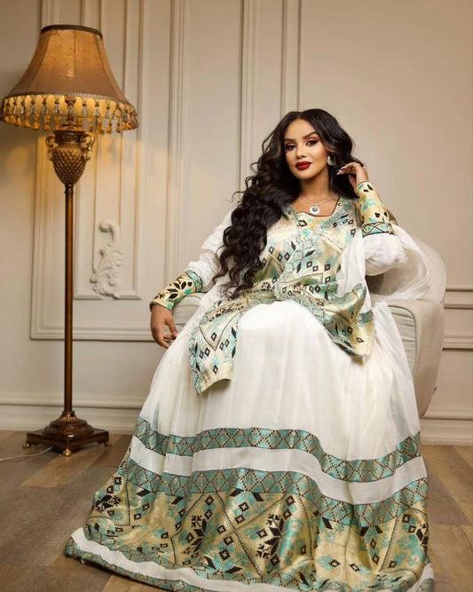 Green Habesha kemis in soft dress featuring gold tibeb embroidery for holiday ceremony