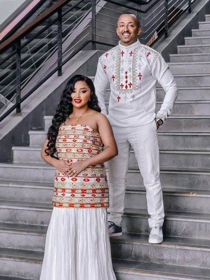 Man and woman in Habesha Couple Matching Set standing on a staircase