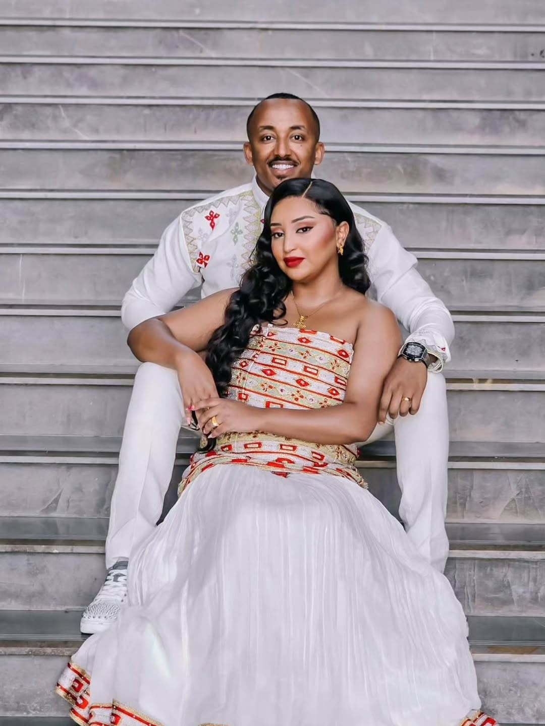 Couple sitting on steps wearing  Habesha Couple Matching Set