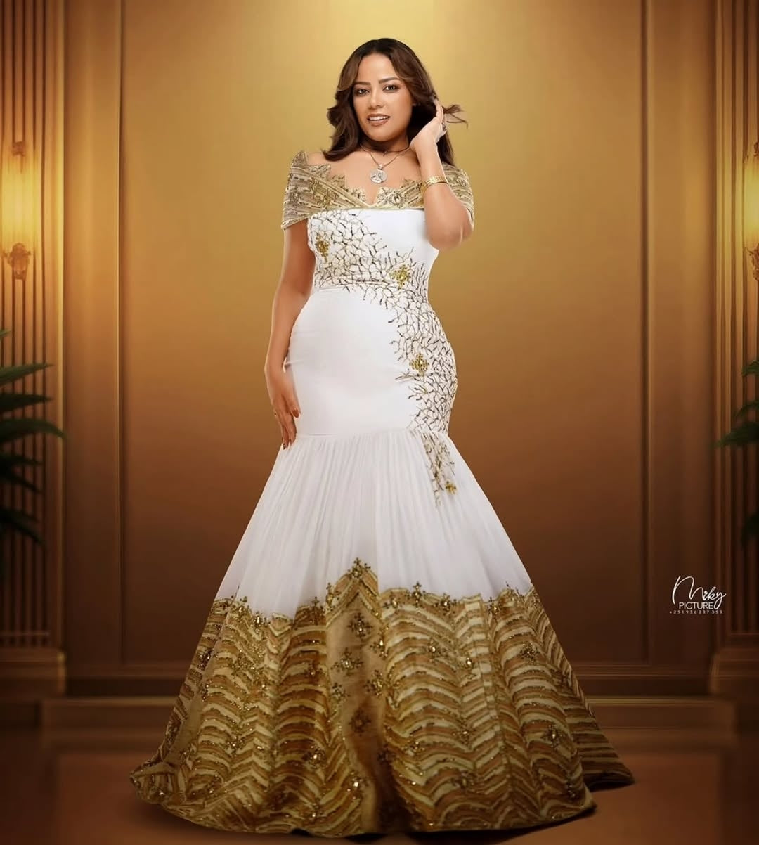 Gold Habesha Kemis – Modern Mermaid Ethiopian Wedding Dress with Off-Shoulder Design and Handcrafted Tilf Embroidery