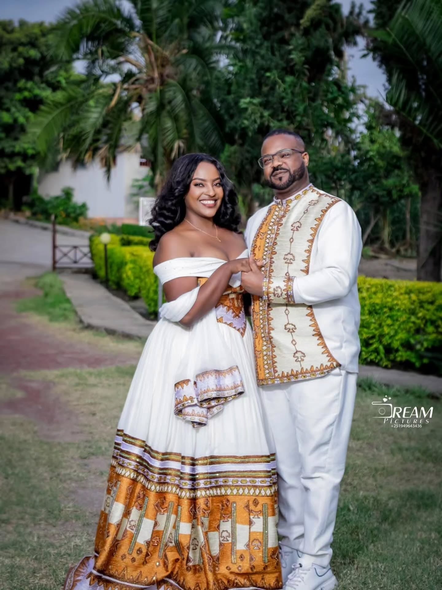 Gold Habesha wedding dress finished with silver tilf embroidery for diaspora weddings and bridal parties