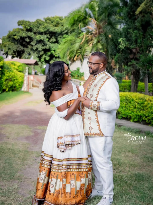 Gold Habesha wedding dress finished with silver tilf embroidery for diaspora weddings and bridal parties