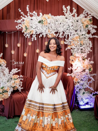 Gold Habesha wedding dress finished with silver tilf embroidery for diaspora weddings and bridal parties