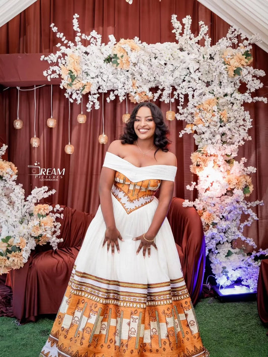 Gold Habesha wedding dress finished with silver tilf embroidery for diaspora weddings and bridal parties