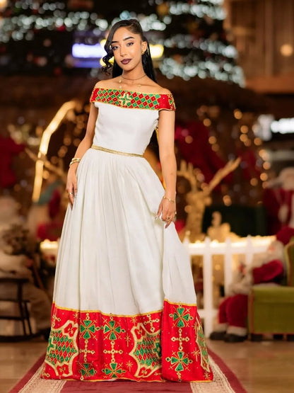 Woman in a white and red Ethiopian traditional dress with festive decorations in the background