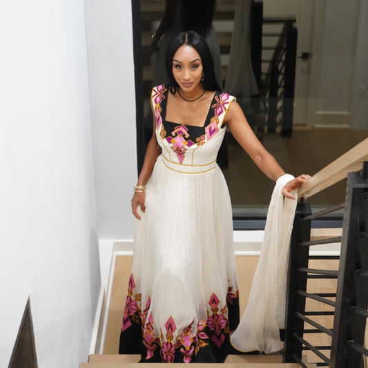 Woman in a floral Ethiopian standing on a staircase