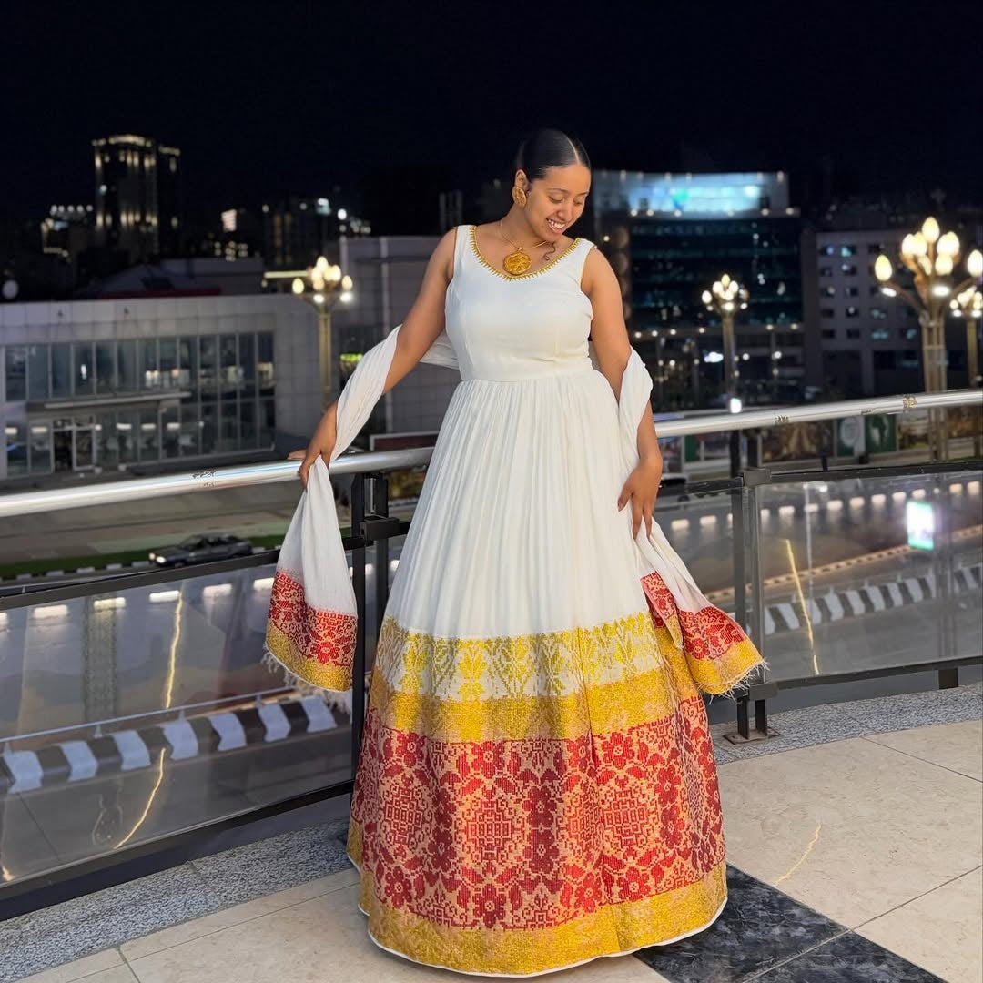 Red and Gold Habesha Kemis – Elegant White Traditional Ethiopian Dress with Vibrant Hand-Embroidered Borders for Special Events and Cultural Holidays