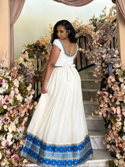 Blue Habesha Kemis – Graceful Handwoven Dress with Hand-Embroidered Tibeb Embroidery for Weddings