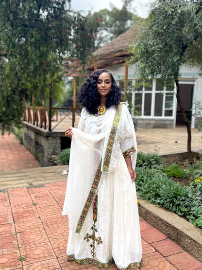 Forest Green Habesha zuria in handwoven cotton featuring silver tibeb embroidery for Fasika gatherings
