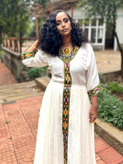 Forest Green Habesha zuria in handwoven cotton featuring silver tibeb embroidery for Fasika gatherings