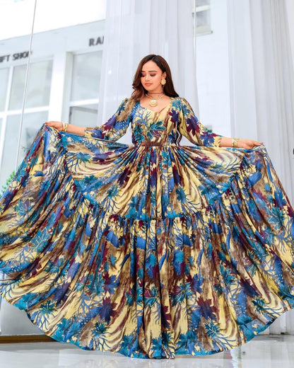 Woman wearing a colorful floral dress in a bright room.
