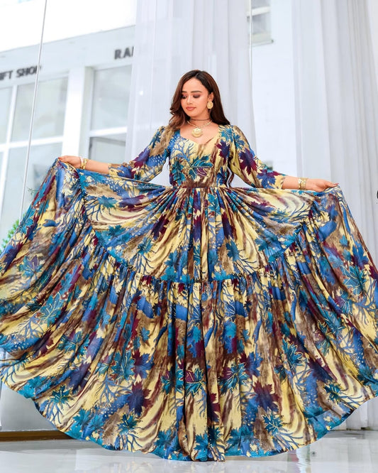 Woman wearing a colorful floral dress in a bright room.