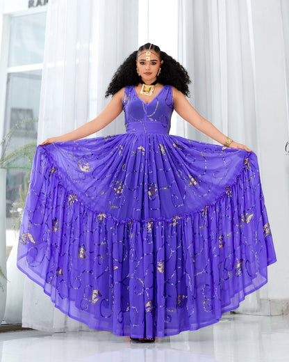 A woman modeling a voluminous purple sleeveless Habesha Dress with gold floral embroidery, holding out the wide skirt against a bright white curtain background.