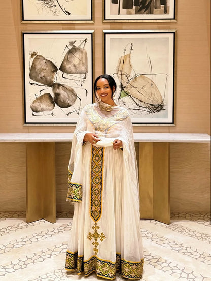 White Habesha Kemis with Gold Tibeb Design – Traditional Ethiopian Dress for Women by Tesfaye Mehari