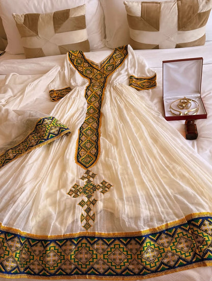 White Habesha Kemis with Gold Tibeb Design – Traditional Ethiopian Dress for Women by Tesfaye Mehari