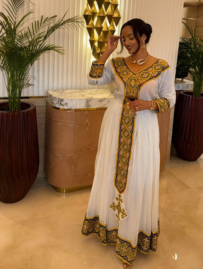 White Habesha Kemis with Gold Tibeb Design – Traditional Ethiopian Dress for Women by Tesfaye Mehari