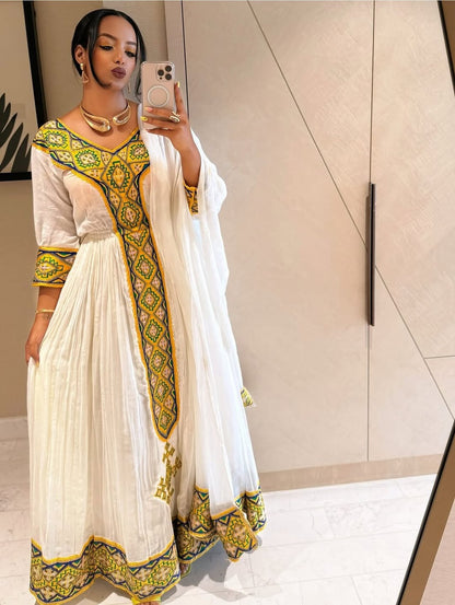 White Habesha Kemis with Gold Tibeb Design – Traditional Ethiopian Dress for Women by Tesfaye Mehari