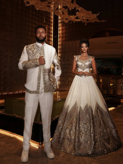 Man and woman in formal Ethiopian Matching Couple Set standing in a luxurious interior setting.